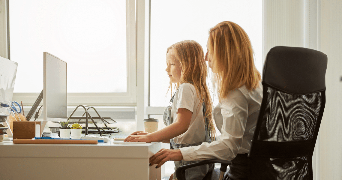 Young mother working at home while her daughter needs attention