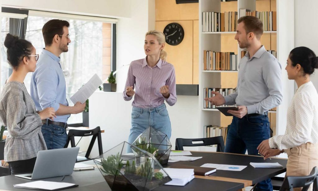 Group of employees in a standing meeting
